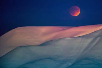  La luna de sangre detrás de una montaña desde Longyearbyen, Svalbard, Noruega. AFP PHOTO/HEIKO JUNGE  