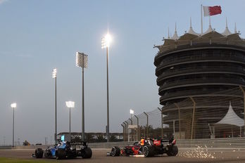 El red Bull de Checo Pérez saca chispas en su persecución a Niocholas Latifi. (Mazen MAHDI/AFP)